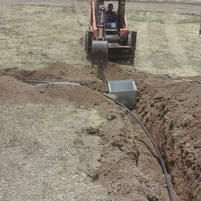 Mini excavator digging drainage trench