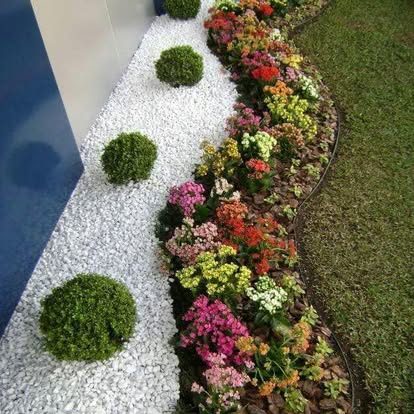 Decorative flower bed with white gravel and topiary